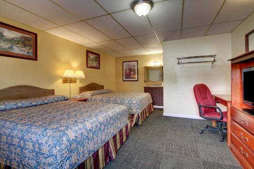 Star Motel tesisinde bir odada yatak veya yataklar
