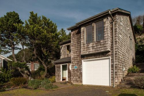 a house with a white garage door on it at Calypso in Lincoln City