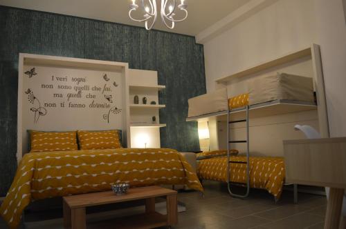 a bedroom with two beds and a bunk bed at Arco Cutò casa vacanze in Palermo