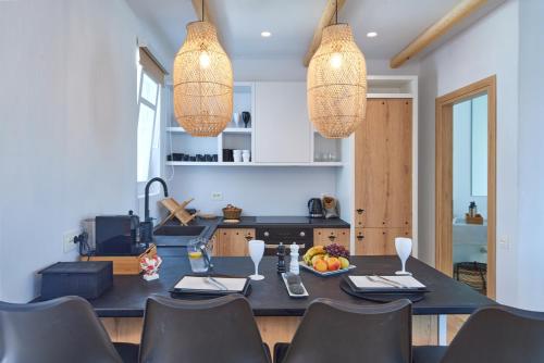 a dining room with a table and chairs and lights at Casa Mardiva Sole in Kampos Paros