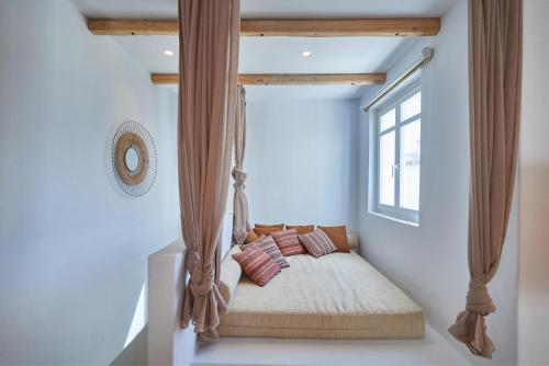a swinging bed in a room with a window at Casa Mardiva Sole in Kampos Paros