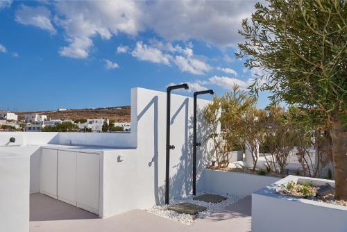 a white fence with a gate and trees at Casa Mardiva Sole in Kampos Paros