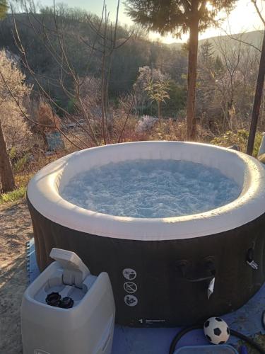 a bath tub with a soccer ball in it at Balaton Sunset apartman in Balatonfůzfő