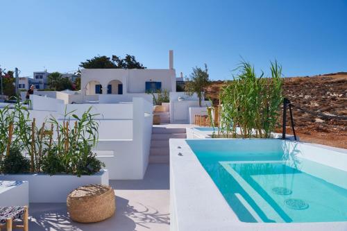 a villa with a swimming pool and white at Casa Mardiva Sole in Kampos Paros