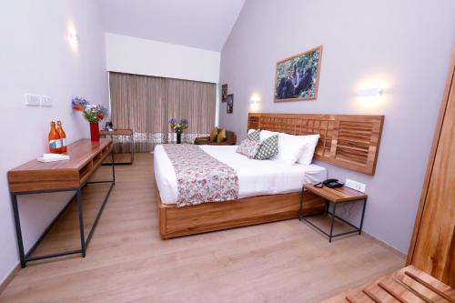 a hotel room with a bed and a desk at Destiny - The Farm Resort in Ooty