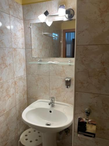 a bathroom with a white sink and a mirror at Atlantic Hotel in Budapest