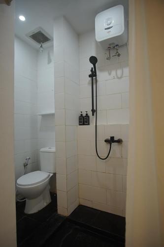 a bathroom with a toilet and a shower stall at Roemah Renjana Yogyakarta in Timuran