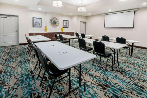 a classroom with tables and chairs and a whiteboard at La Quinta Inn & Suites by Wyndham Fort Worth Arlington West in Arlington