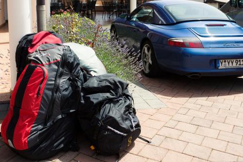 a pile of luggage sitting on the sidewalk next to a car at Hotel Penzion Kobala in Tolmin