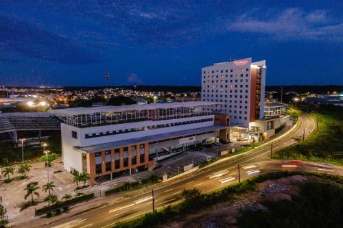 a large building with a highway in front of it at Ramada by Wyndham Manaus Torres Center in Manaus