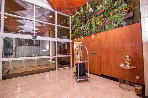 a lobby with a luggage cart in a building at Ramada by Wyndham Manaus Torres Center in Manaus