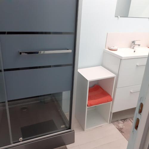 a small bathroom with a sink and a glass cabinet at Chambres d'hôtes GOBILLON in Maintenon