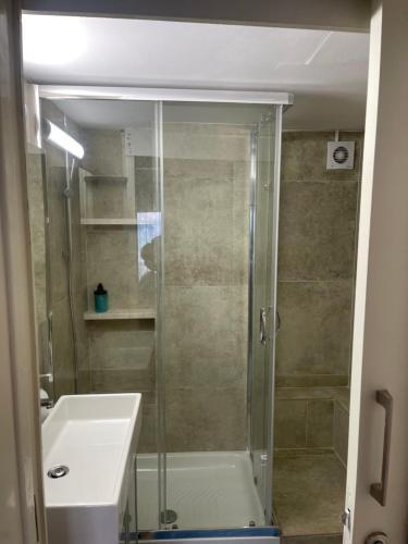a bathroom with a shower and a sink and a toilet at Alex Beach Apartment 31 in Larnaca