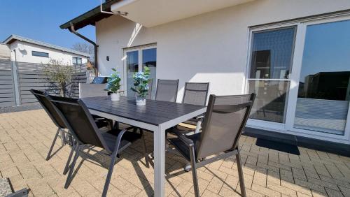 a black dining table and chairs on a patio at Ferienhaus Antiquarius in Bendorf