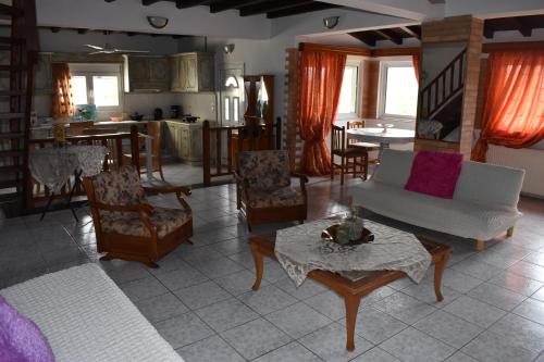 a living room with a couch and chairs and a table at Kerasia's and Dora's garden in Punta