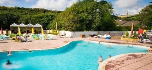 a large swimming pool with people in the water at 58 Newquay View, Newquay Bay Resort in Newquay Bay Resort