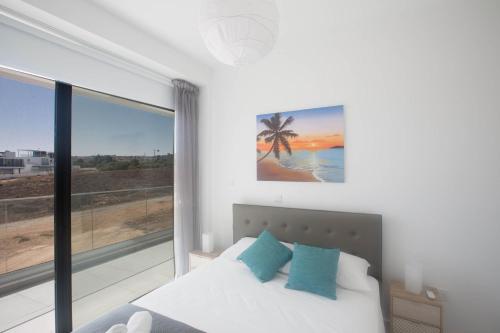 a bedroom with a bed and a large window at Anassa Seaview Villa - Stunning Panoramic Views in Protaras