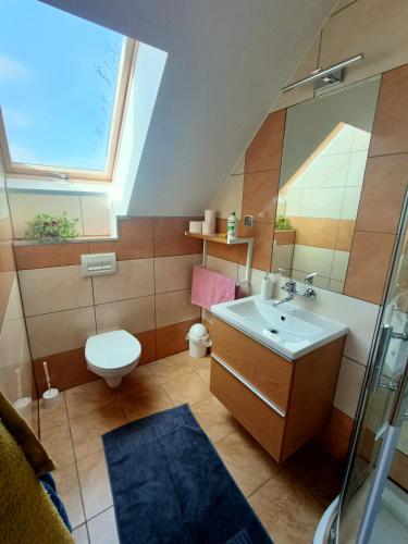 a bathroom with a sink and a toilet and a window at Noclegi Zielona Góra u Moni in Zielona Góra