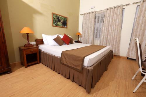 a bedroom with a large bed in a room at Destiny - The Farm Resort in Ooty