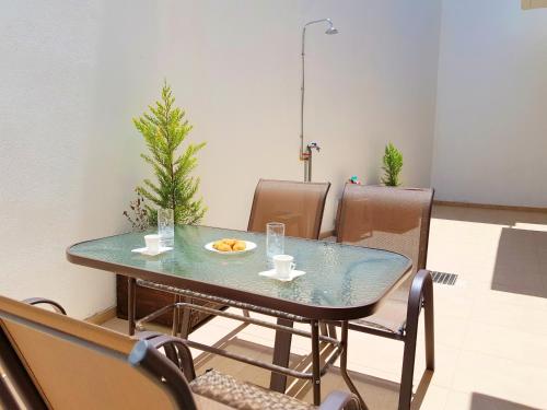 a dining room with a table with a plate of food on it at New Villa Kalimera, view to Falasarna beach in Plátanos