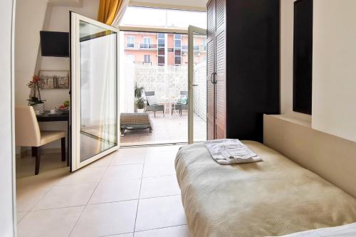 a bedroom with a bed and a view of a patio at Hotel Poetto in Cagliari