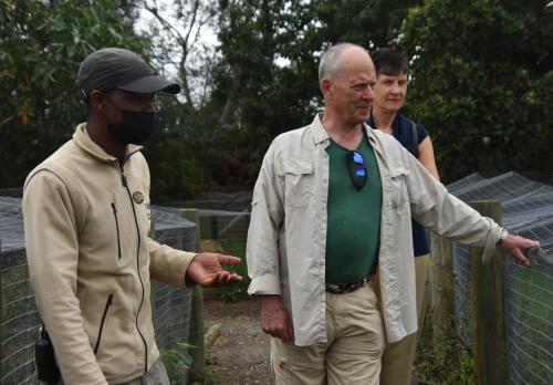 a man wearing a mask standing next to another man at Tenikwa Wildlife Centre & Spa in Plettenberg Bay