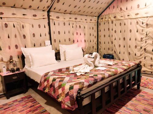 A bed or beds in a room at Dev Bhoomi Farms & Cottages