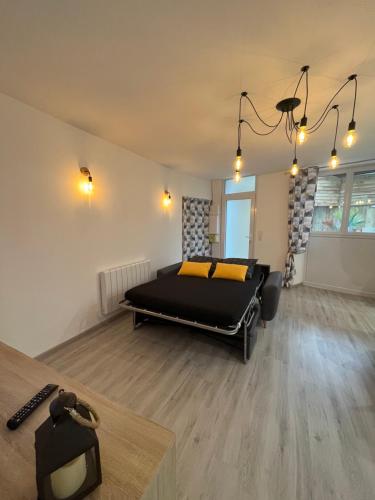 a bedroom with a bed in the middle of a room at Le beauvais in Évron