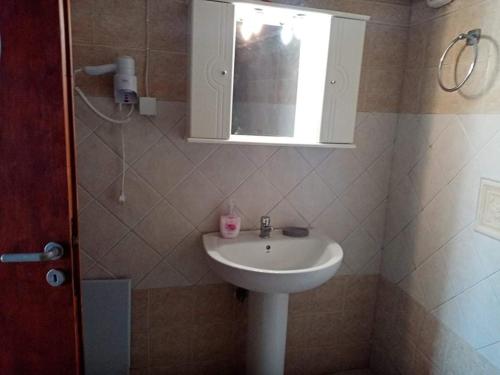 a bathroom with a white sink and a mirror at H&M Prive HOME MÀRGARITES RETHYMNO 115sqm in Margarítai