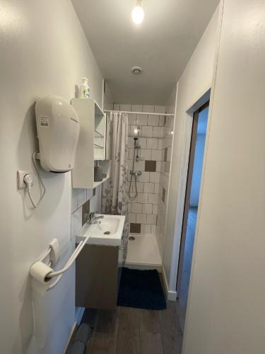 a white bathroom with a sink and a toilet at LA VILLA DEKO - Studio avec parking proche Université et Hôpital in Beuvry