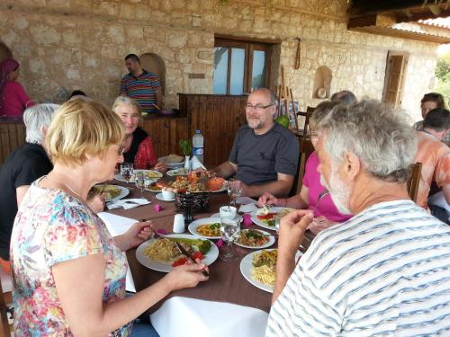 a group of people sitting around a table eating food at Beymelek Tas Evler in Demre