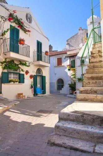 a building with stairs in front of a street at B&B La Maison del Borgo in Rodi Garganico