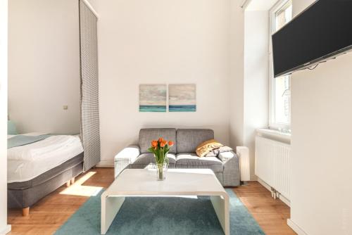 a living room with a couch and a table at Luxurious and Bright, 5 min to city center in Vienna