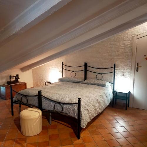 a bedroom with a large bed in a room at MANSARDA VITI - Sguardo su Frontone - in Frontone