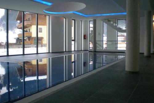 a large building with a pool in the middle of a building at Daniela 3 by SMR Rauris Apartments - inc Spa and National Summercard - near Gondola in Rauris