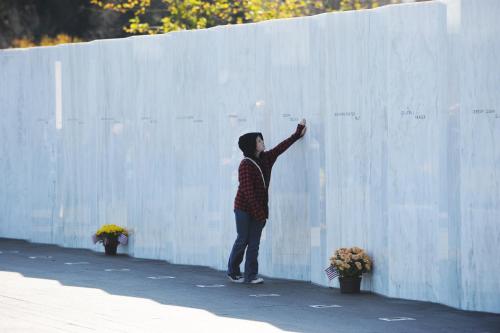 a woman standing next to a white wall at Ramada by Wyndham Ligonier in Ligonier