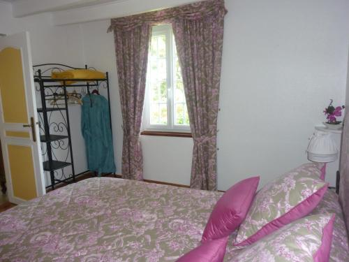 a bedroom with a bed and a window at Chambre d'hôtes Au Fil De L'eau in Jumièges