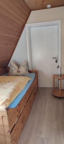 a bedroom with a bed with a large window at Ferienwohnung im Rohrdachhaus in Wustrow