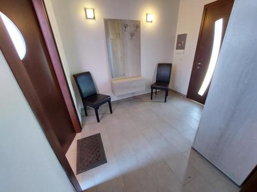 an empty hallway with two chairs and a window at Holiday Home Matthäus am Corfutrail, Ferienoase im Olivenhain 3 km zum Meer in Giannádes
