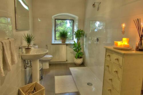 a bathroom with a sink and a toilet and a sink at Villa Selva in Lastra a Signa