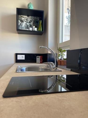 a kitchen counter with a sink and a window at Sapore Di Sale Accommodation Tropea in Tropea