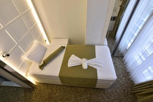 a room with a bed with a bow on it at Airport Trabzon Otel in Bostancı