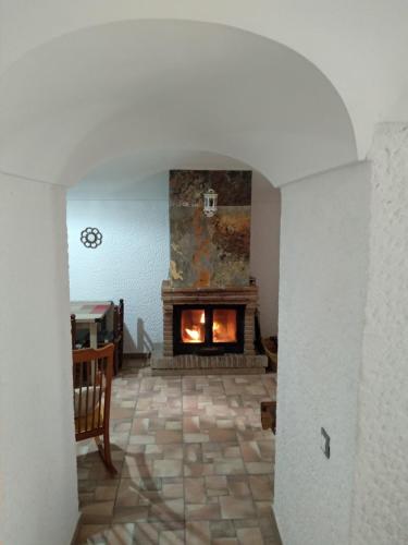 a living room with a fireplace in the middle at Cuevas Uropia in Graena