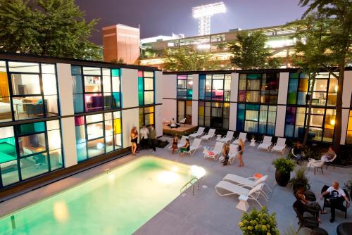 a building with a pool and people sitting around it at The Verb Hotel in Boston