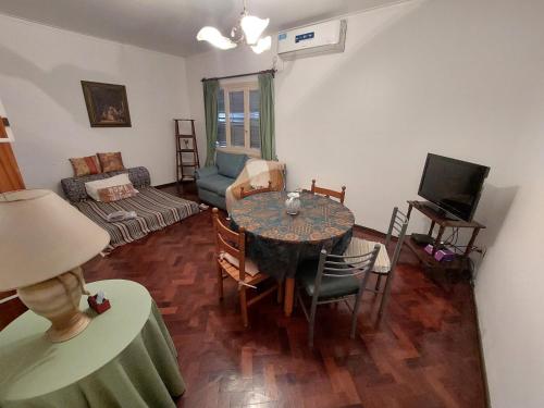 a living room with a table and a couch at Departamento peatonal Mendoza in Mendoza