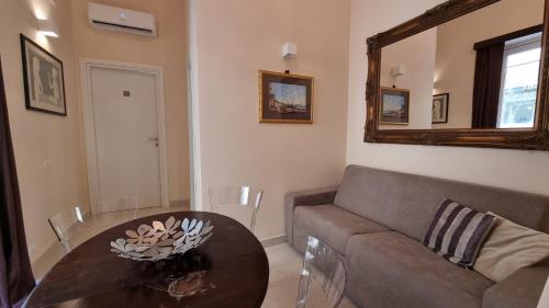 a living room with a couch and a table at FERDINANDO HOME in Caserta
