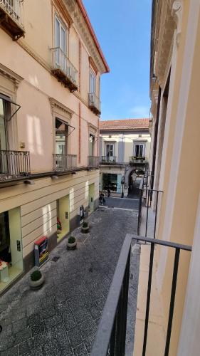 an empty courtyard of a building with a balcony at FERDINANDO HOME in Caserta