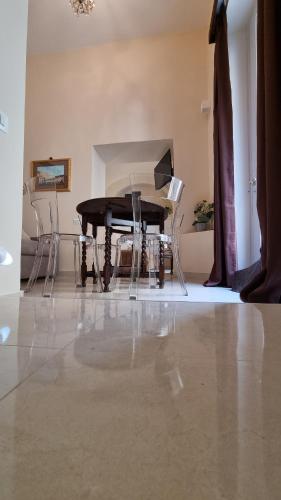 a black piano sitting in a room with chairs at FERDINANDO HOME in Caserta