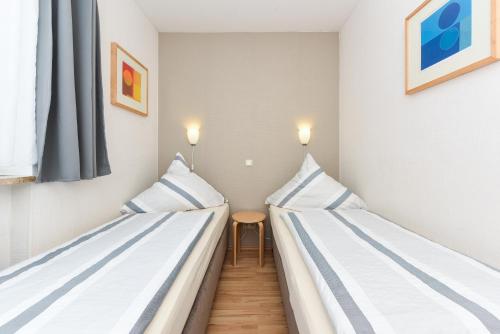 Un pat sau paturi într-o cameră la Klippersteven