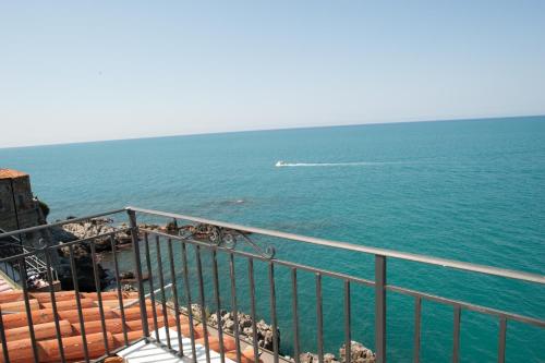 a view of the ocean with a boat in the water at MiraMare Residence Cefalú in Cefalù